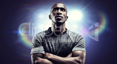 Composite image of thoughtful rugby player with arms crossed