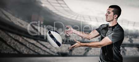 Composite image of rugby player catching ball