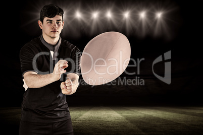 Composite image of rugby player throwing a rugby ball