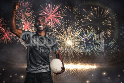 Composite image of happy sportsman with clenched fist holding ru