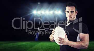 Composite image of tough rugby player looking at camera