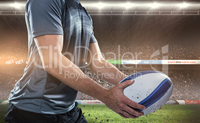 Composite image of midsection of rugby player in black jersey ho