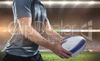 Composite image of midsection of rugby player in black jersey ho