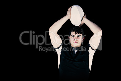 Composite image of portrait of a rugby player throwing a ball