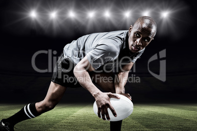 Composite image of determined sportsman looking away while playi