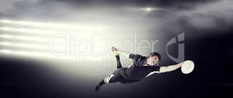 Composite image of a rugby player scoring a try