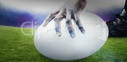 Composite image of cropped image of sportsman holding rugby ball