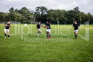 Rugby players training on pitch