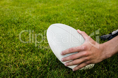 Rugby player picking up ball