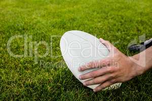 Rugby player picking up ball