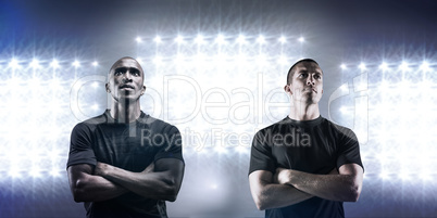 Composite image of thoughtful rugby player with arms crossed