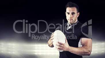 Composite image of tough rugby player looking at camera