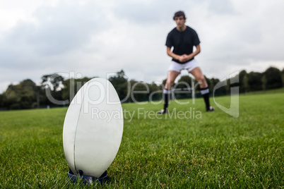 Rugby player about to kick ball