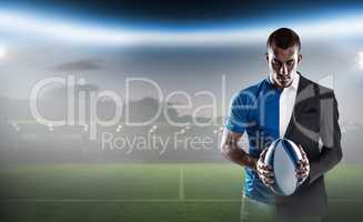 Composite image of rugby player holding ball