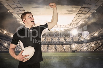 Composite image of a rugby player gesturing victory