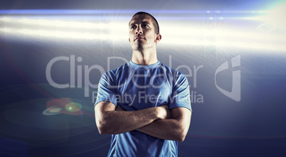 Composite image of confident rugby player looking away with arms