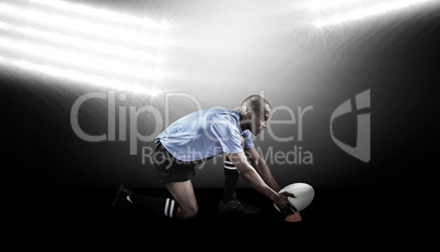 Composite image of rugby player keeping ball on kicking tee