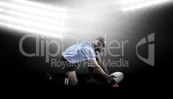 Composite image of rugby player keeping ball on kicking tee