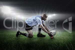 Composite image of rugby player keeping ball on kicking tee