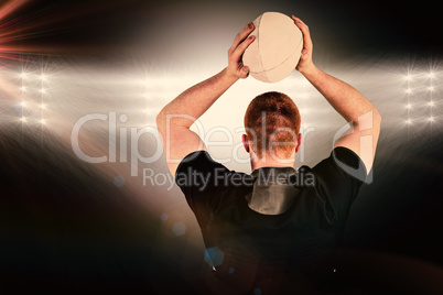 Composite image of rugby player about to throw a rugby ball