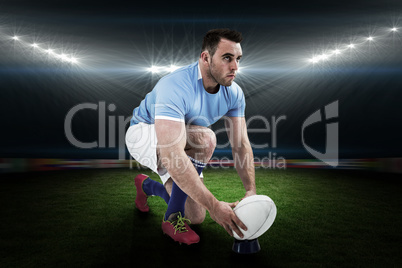 Composite image of rugby player ready to kick