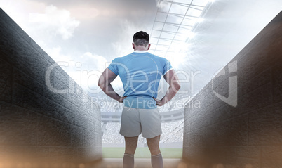 Composite image of rugby player with hands on hips