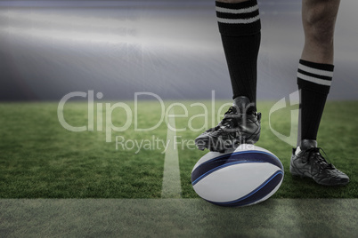 Composite image of rugby player in black socks on ball