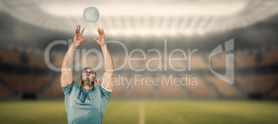 Composite image of rugby player catching the ball