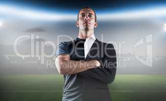 Composite image of confident rugby player with arms crossed