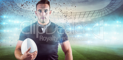 Composite image of tough rugby player holding ball