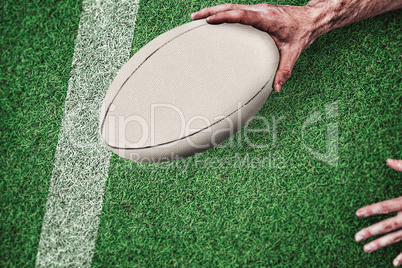 Composite image of cropped image of a man holding rugby ball