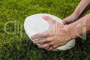 Rugby player picking up ball