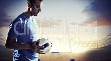 Composite image of thoughtful sports player holding ball