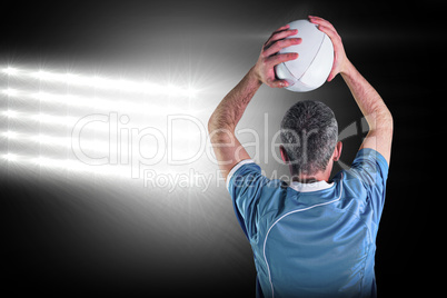 Composite image of rugby player about to throw a rugby ball