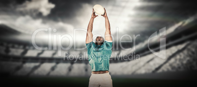 Composite image of rugby player catching the ball