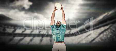 Composite image of rugby player catching the ball