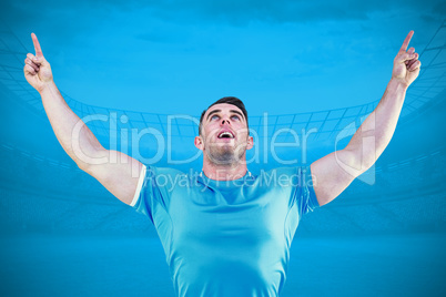 Composite image of rugby player cheering and pointing