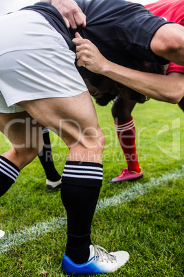 Rugby players doing a scrum