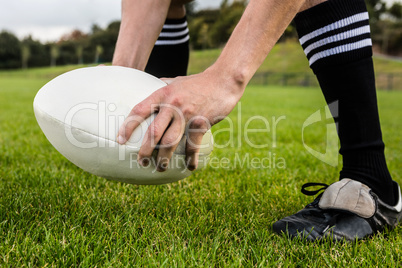 Rugby player about to kick ball