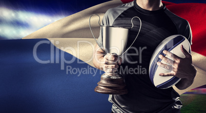 Composite image of midsection of successful rugby player holding