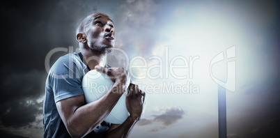Composite image of rugby player catching ball while playing