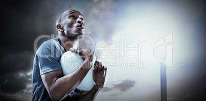 Composite image of rugby player catching ball while playing