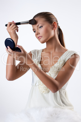 Young Woman Applying Cosmetics