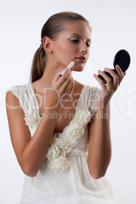 Young Woman Applying Cosmetics