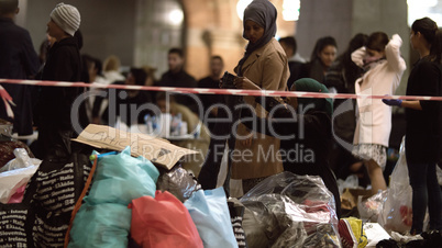 Syrian Refugees Listening to Announcement at Charity Collecting Point in Copenhagen Railroad Station