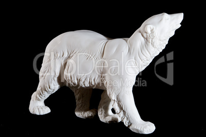 Classic white marble statuette of bear isolated on black background