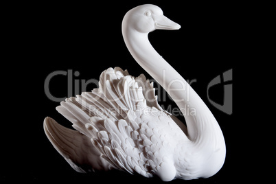 Classic white marble statuette of swan isolated on black background
