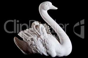 Classic white marble statuette of swan isolated on black background