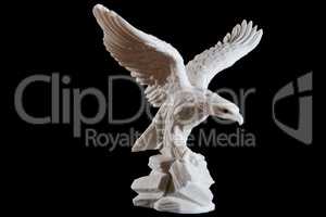 Classic white statuette of eagle isolated on black background