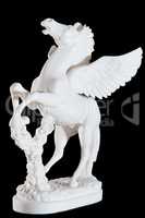 Classic white marble statuette of bucking pegasus isolated on black background